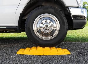 yellow leveling block underneath truck tire