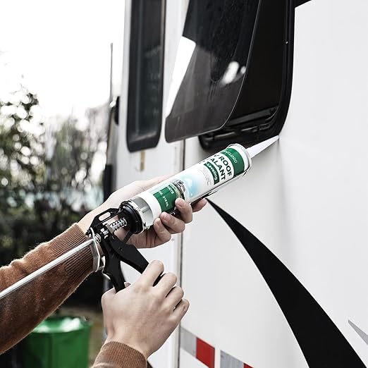 person's hands holding self leveling sealant to rv window to apply